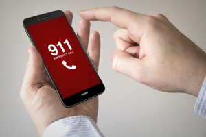 Close up of man using 3d generated mobile smart phone with emergency call on the screen. Screen graphics are made up.